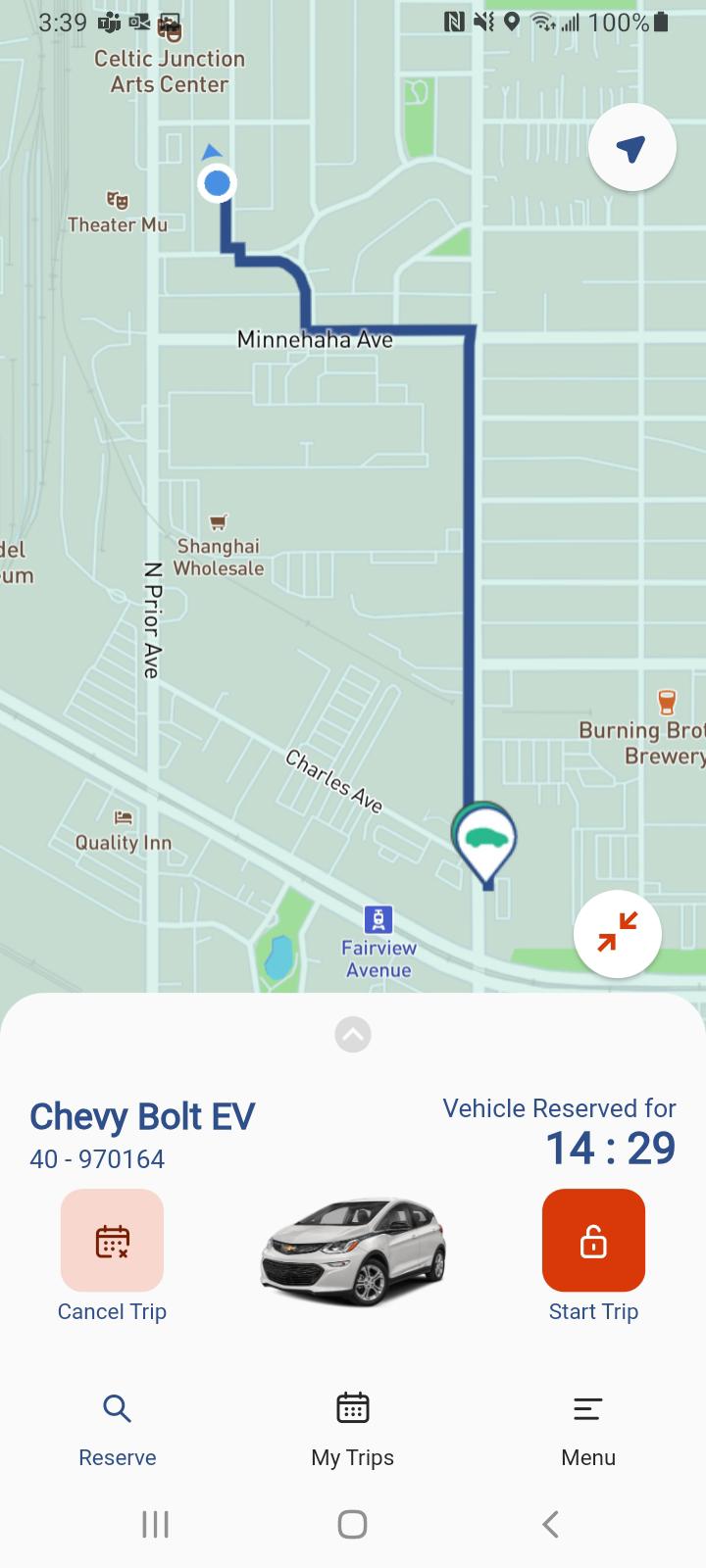 the app showing a reserved Evie trip, with walking directions to the car on the map