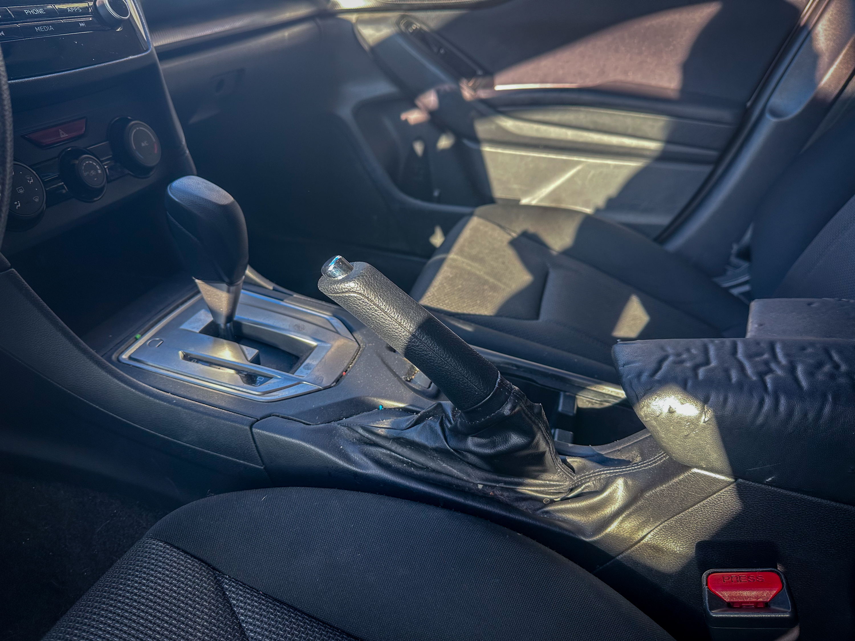 A photo of the Subaru Impreza Hatchback parking brake lever, located in the center console
