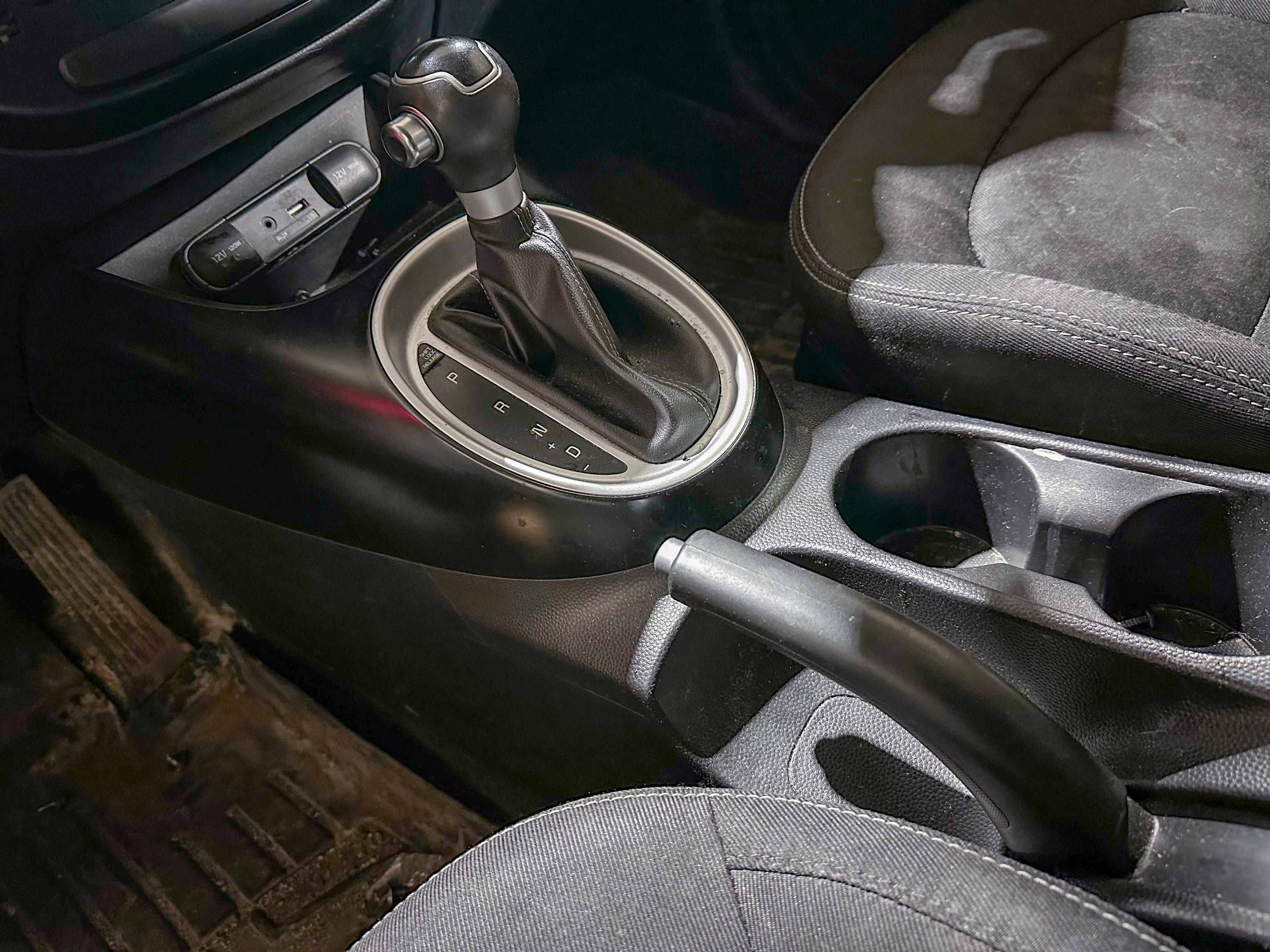 A photo of the Kia Soul parking brake lever in its off position, located in the center console